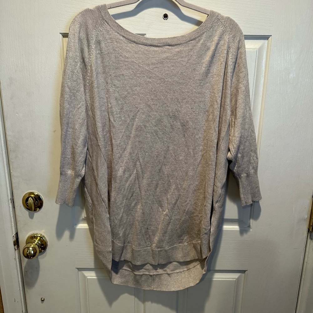 Express cream 3/4 sleeve sweater with rounded bottom hem and cris cross on back